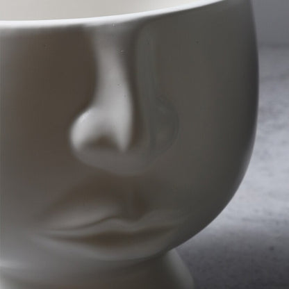 Cache-pot visage